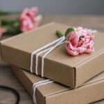 pink flower and wrapped boxes on a wood table 2026 03 17 05 04 21 utc
