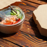 take out poke bowl on wooden background 2026 03 19 08 14 28 utc