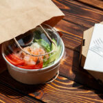 take out poke bowl on wooden background 2026 03 24 10 27 15 utc