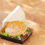 tasty burger in box on brown color cloth 2026 03 09 07 09 22 utc