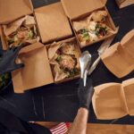 top view man is packing food into the paper eco b 2026 03 24 07 06 24 utc