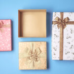 top view of open gift box and presents on blue bac 2026 03 19 02 12 12 utc