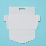 unfolded white cardboard box on a blue background 2026 03 24 14 21 39 utc