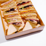 various sandwiches arranged in a takeout box for a 2026 03 24 05 09 09 utc