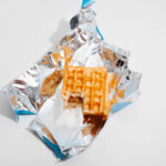 viennese waffle with bitten off piece on shiny ope 2026 03 23 23 02 04 utc