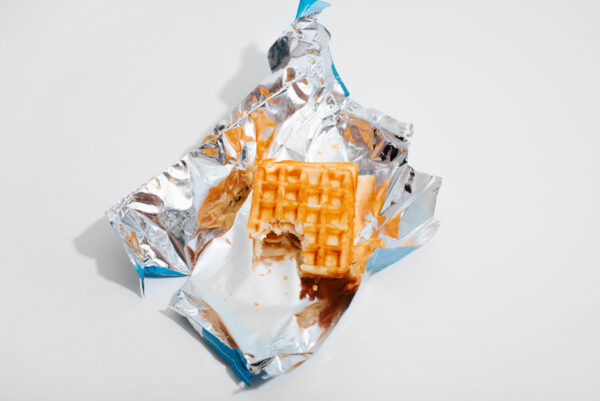 viennese waffle with bitten off piece on shiny ope 2026 03 23 23 02 04 utc