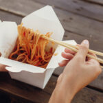 wok with noodles and vegetables in carton box to g 2026 01 09 10 44 11 utc