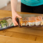woman holding box of sushi for delivery 2026 01 05 06 28 46 utc