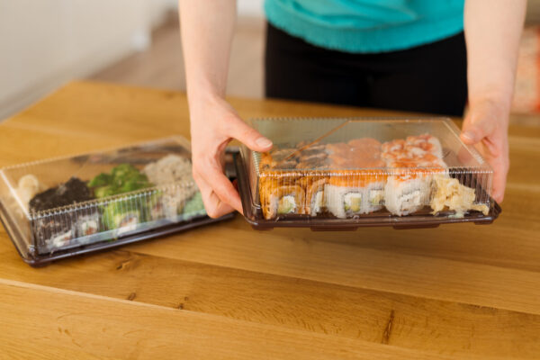 woman holding box of sushi for delivery 2026 01 05 06 28 46 utc