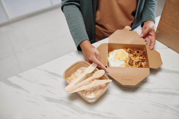 woman opening box of food 2026 03 18 05 30 43 utc