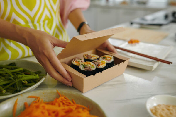 woman packing sushi in carton box 2026 01 08 00 10 16 utc
