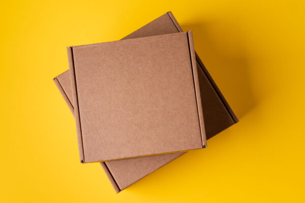 beige cardboard boxes on yellow background close 2026 01 08 22 41 55 utc