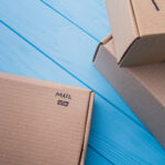 cardboard boxes labeled mail on blue wooden surfac 2026 03 09 04 51 58 utc