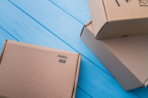cardboard boxes labeled mail on blue wooden surfac 2026 03 09 04 51 58 utc