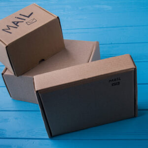 cardboard mail boxes on blue wooden background 2026 03 09 05 39 56 utc
