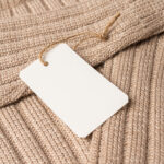 close up of knitted beige clothing with tag 2026 03 17 01 35 12 utc