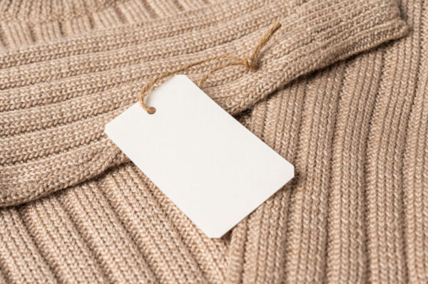 close up of knitted beige clothing with tag 2026 03 17 01 35 12 utc