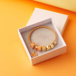 elegant gold charm bracelet in a white box 2026 03 24 01 26 49 utc