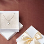 elegant necklace and gift box on brown background 2026 03 24 11 43 15 utc