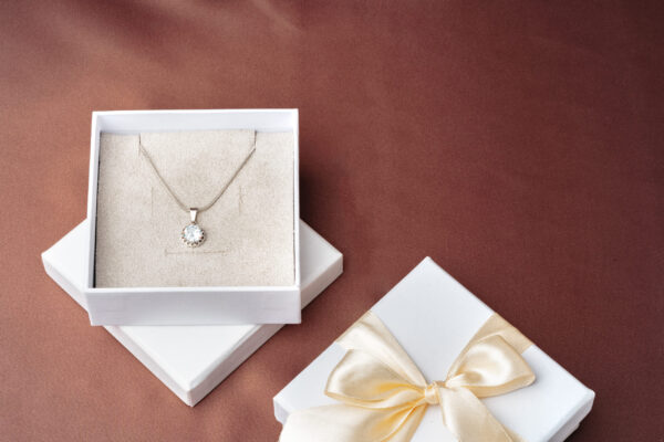 elegant necklace and gift box on brown background 2026 03 24 11 43 15 utc