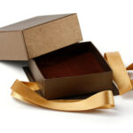 empty gift box with gold ribbon on white 2026 03 25 06 00 14 utc