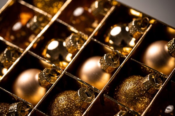golden christmas ornaments in a box close up 2026 03 16 06 06 04 utc
