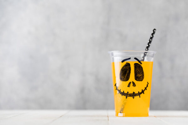 halloween drink with spooky face on white table 2026 03 19 04 19 34 utc