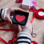 hands preparing a heart gift with ribbon 2026 01 05 04 37 33 utc