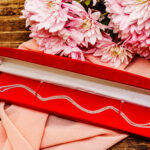 necklace in red box with pink flowers 2026 03 26 05 24 26 utc