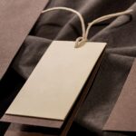neutral clothing tag with textured fabric backdrop 2026 03 18 07 04 34 utc