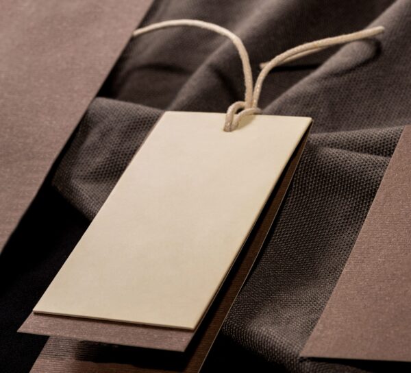 neutral clothing tag with textured fabric backdrop 2026 03 18 07 04 34 utc