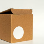 open brown box with a white round label 2026 03 16 00 34 50 utc