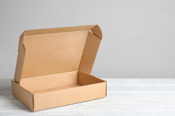 open brown cardboard box on white wooden surface 2026 03 27 17 27 02 utc