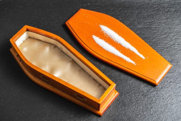 open coffin with two lines of white powder 2026 03 13 04 24 39 utc