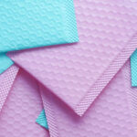 pink and green color paper bubble envelope on tabl 2026 03 16 03 22 40 utc