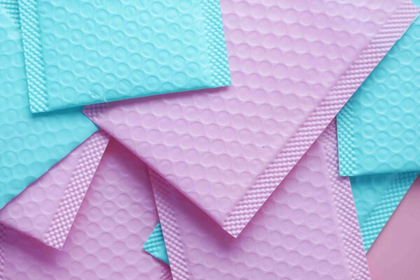 pink and green color paper bubble envelope on tabl 2026 03 16 03 22 40 utc