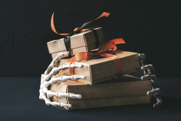 spooky gifts held by skeleton hands for halloween 2026 03 20 03 12 48 utc