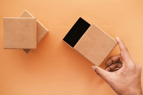 top view of person open a empty small gift box 2026 03 16 03 03 19 utc