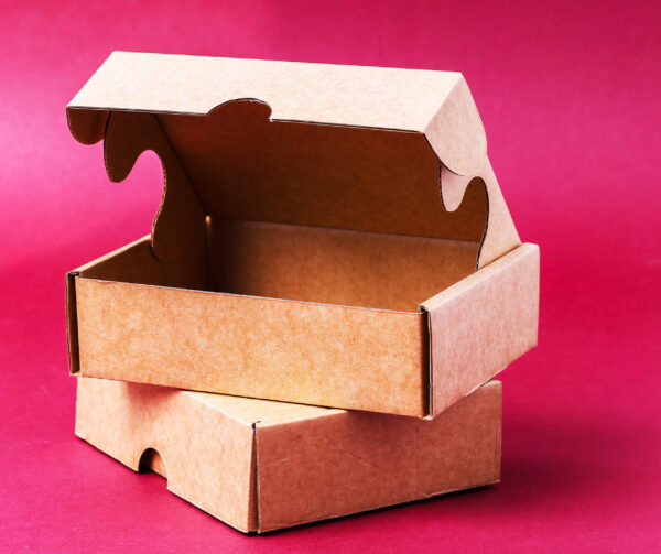 two brown cardboard boxes on red background 2026 03 25 01 40 52 utc