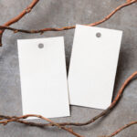 two white tags with branch on gray background 2026 04 17 17 28 58 utc