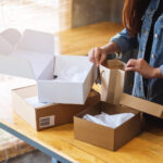 woman arranging boxes and bags on wooden table 2026 01 06 09 20 29 utc
