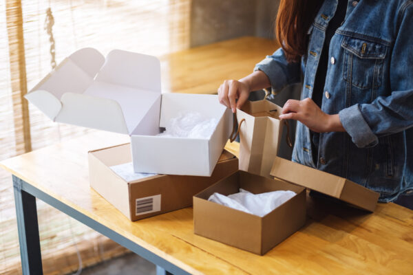 woman arranging boxes and bags on wooden table 2026 01 06 09 20 29 utc