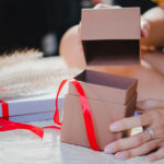 woman opening gift box tied with ribbon 2026 01 06 00 49 45 utc