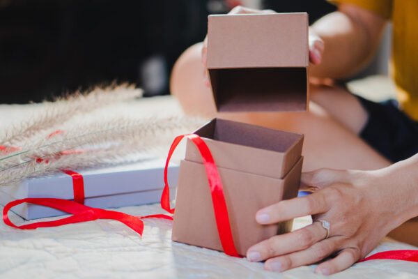 woman opening gift box tied with ribbon 2026 01 06 00 49 45 utc