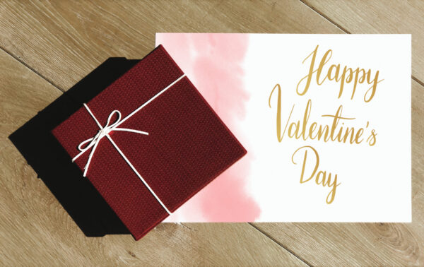 wrapped gift and valentine s day card on table 2026 01 07 23 35 55 utc
