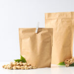 pistachios in brown paper bags with green leaves 2026 03 24 23 18 07 utc